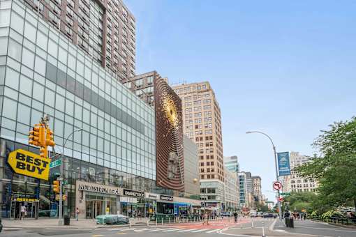 A city street with Best Buy and Acura dealerships.