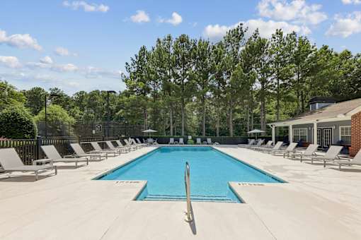 Outdoor swimming pool with lounge chairs at Lancaster Place Apartments in Calera, AL offering a relaxing community amenity near Interstate 65.