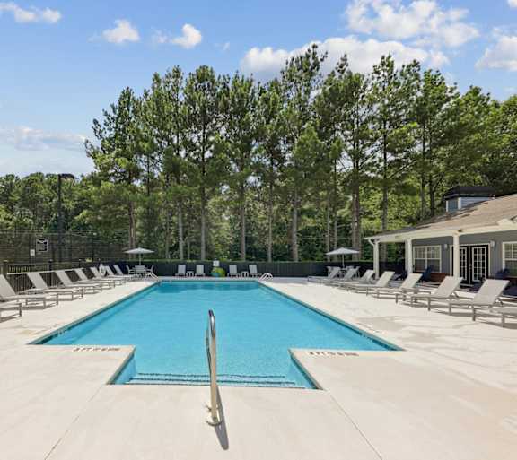 Outdoor swimming pool with lounge chairs at Lancaster Place Apartments in Calera, AL offering a relaxing community amenity near Interstate 65.