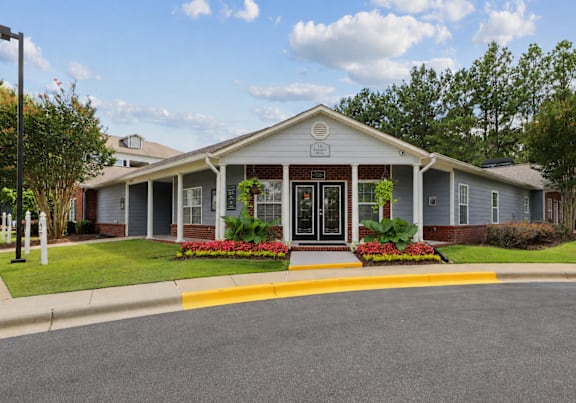 Leasing office entrance at Lancaster Place Apartments in Calera, Alabama featuring professional landscaping and convenient access to Shelby County and Birmingham metro employers.
