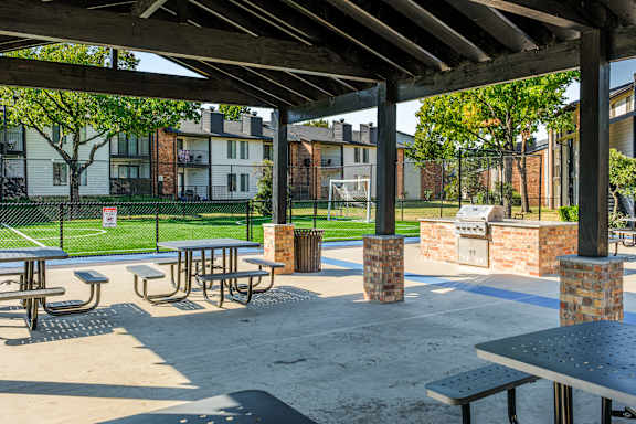 A park with tables and benches under a roof at Water Ridge Apartments , Irving, Texas