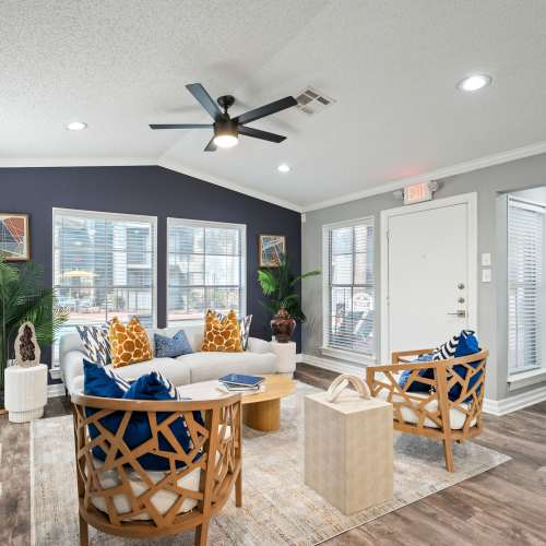 Bright room with sofa and ceiling fan at North Bend Living in Houston, Texas