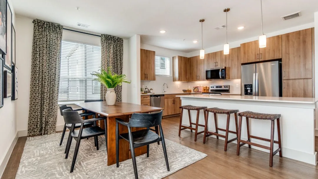 Modern kitchen and dining area with stylish decor and wooden furniture.