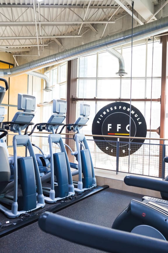 a gym with cardio equipment and a sign in the window at Presidential Towers, Chicago, IL, 60661