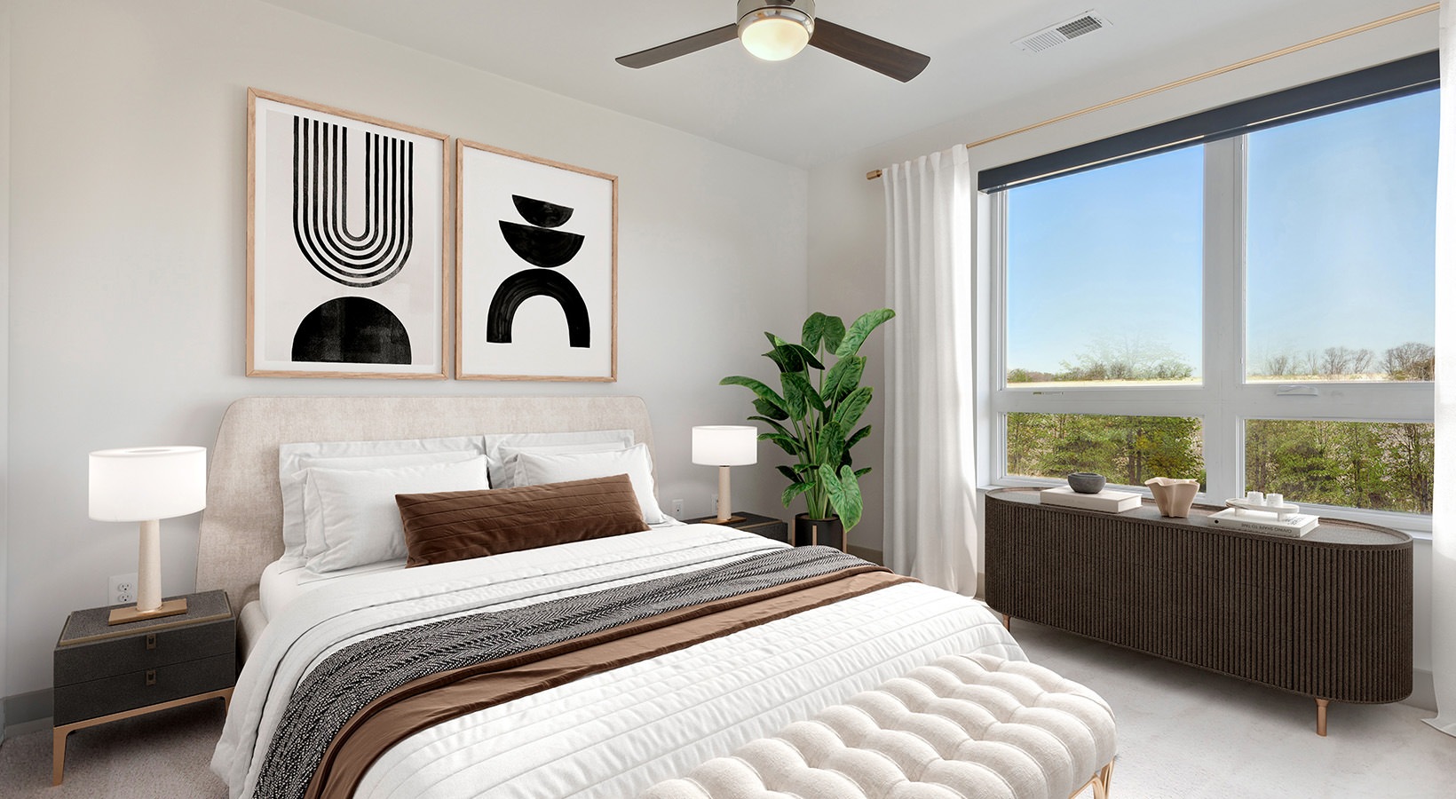 bedroom with bed wall art and large window