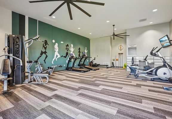 Willowstone Apartments fitness center in Denver CO offering multiple cardio machines and a bright, open exercise area
