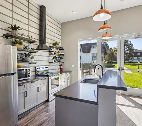 A modern living room with a fireplace and a dining table set for two.