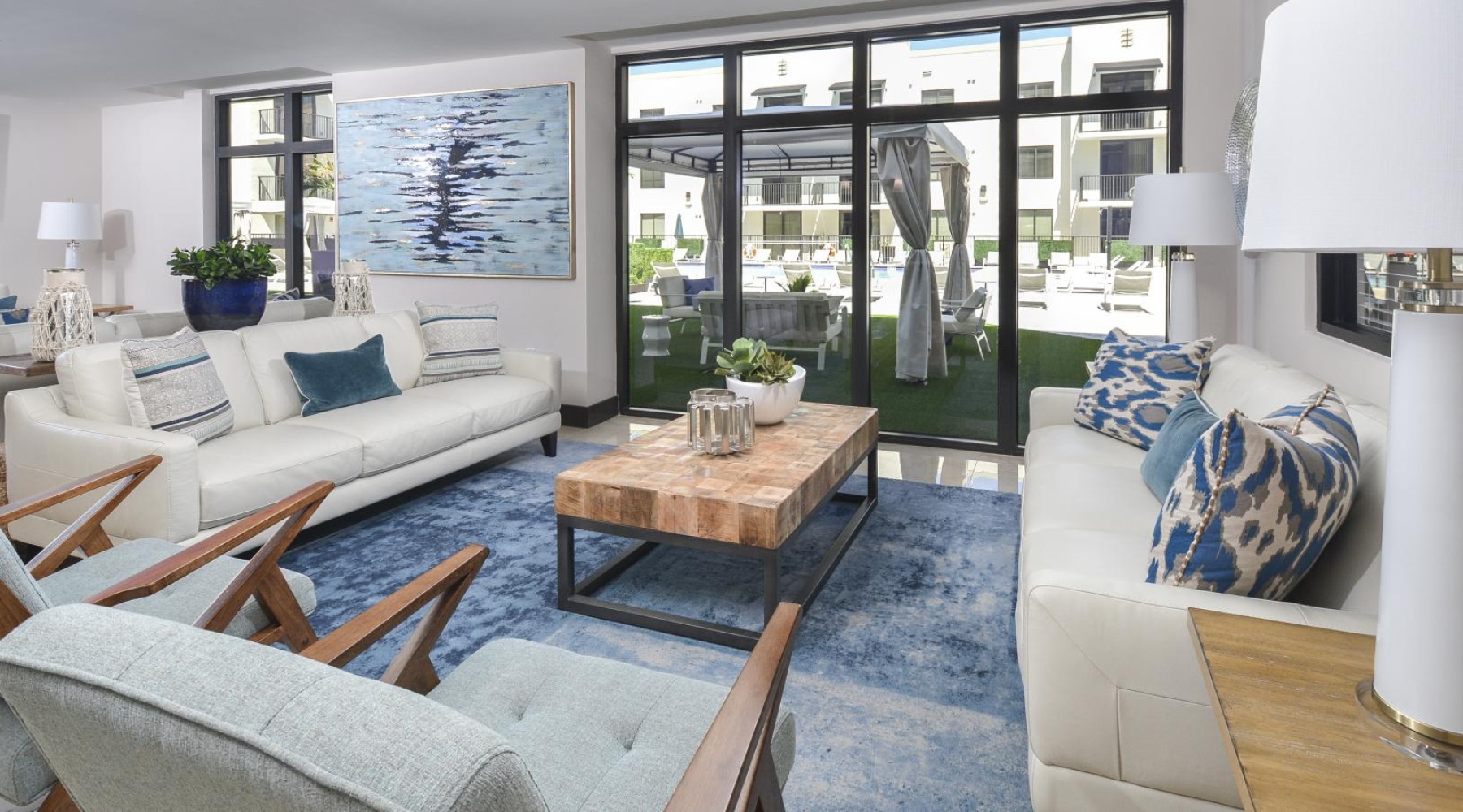 a living room with a large glass door and windows