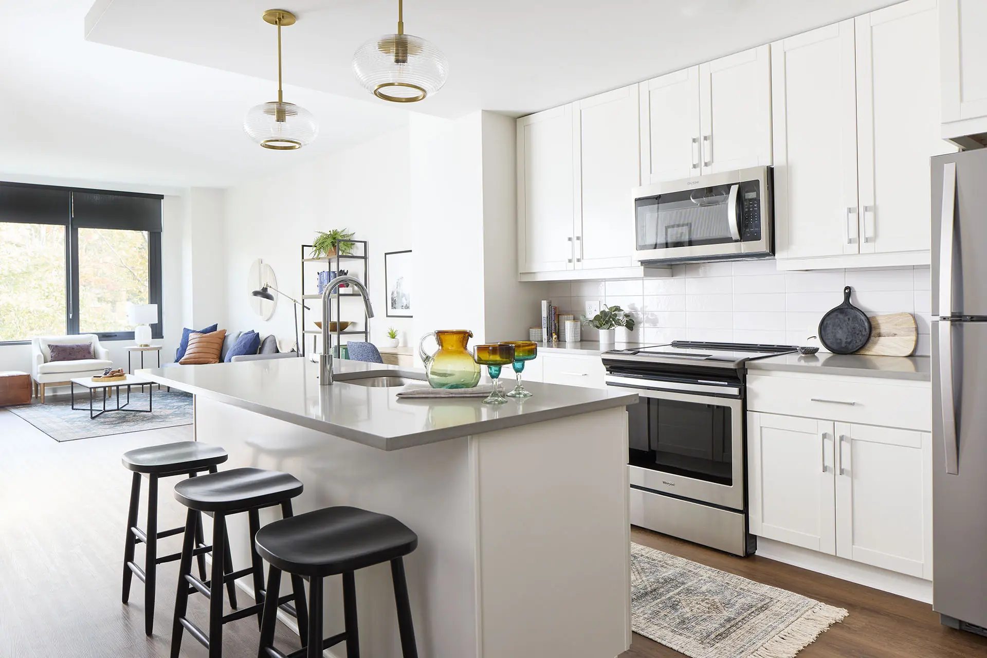 All white open concept kitchens with brass and chrome finishes