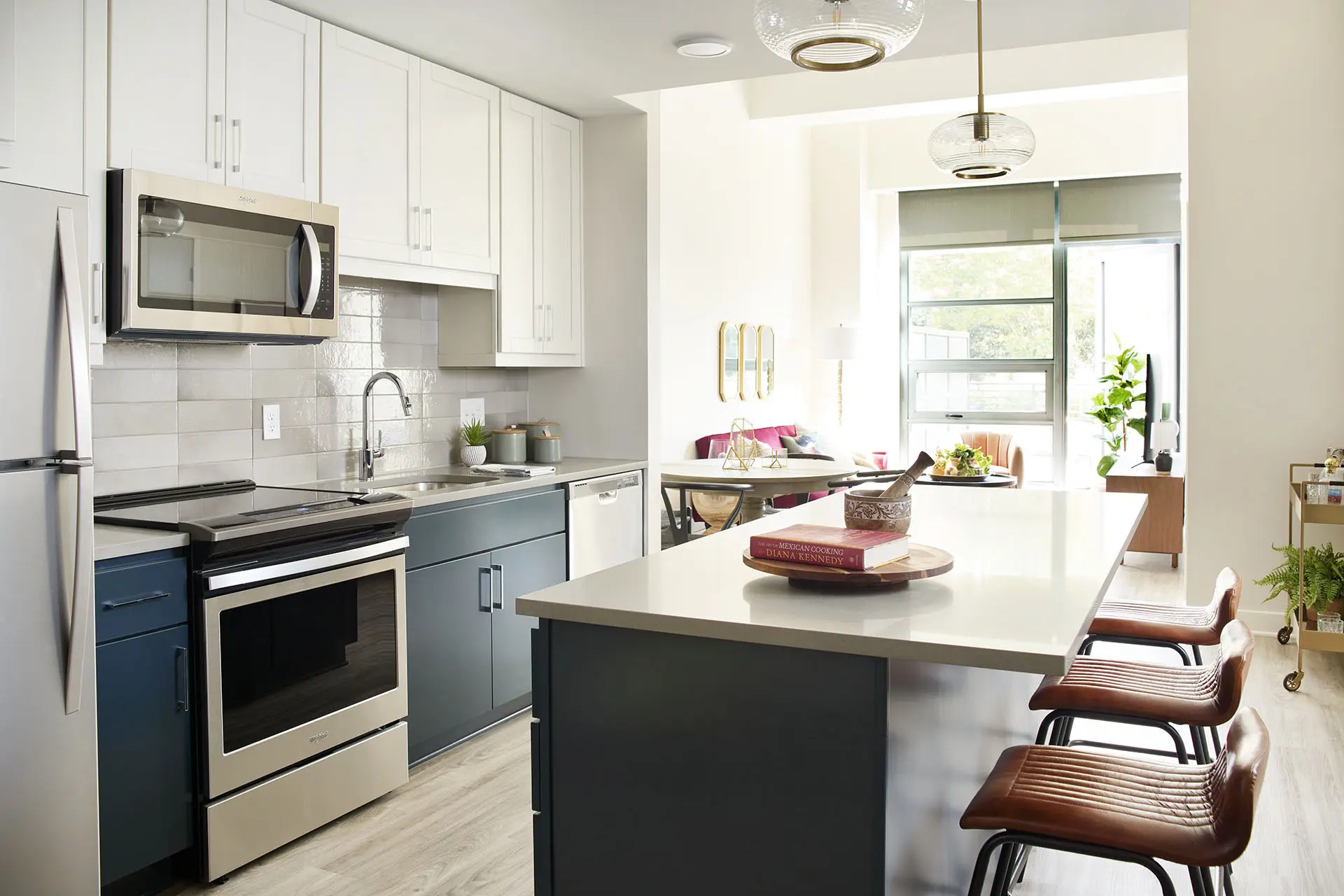 Detailed with stainless steel appliances, quartz countertops and expansive islands