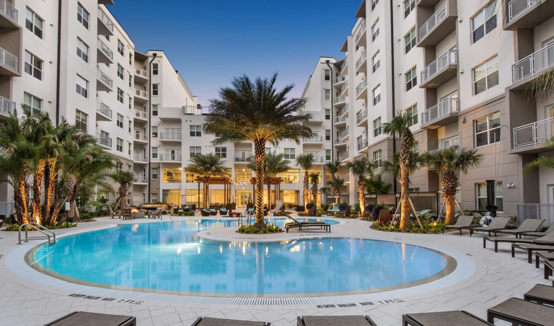 a pool in a courtyard between buildings