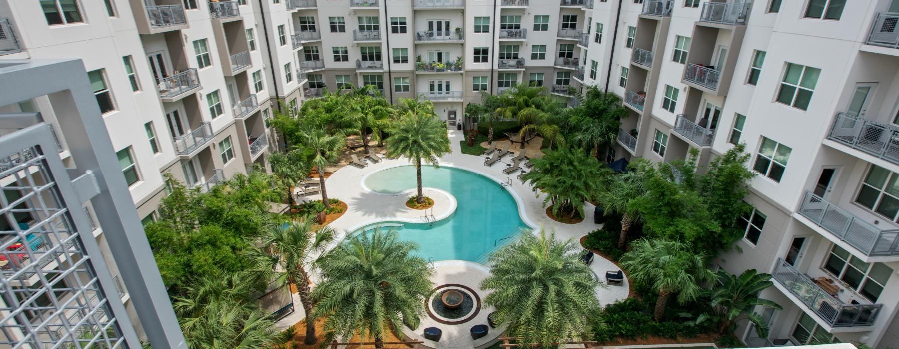 a pool in a courtyard between buildings