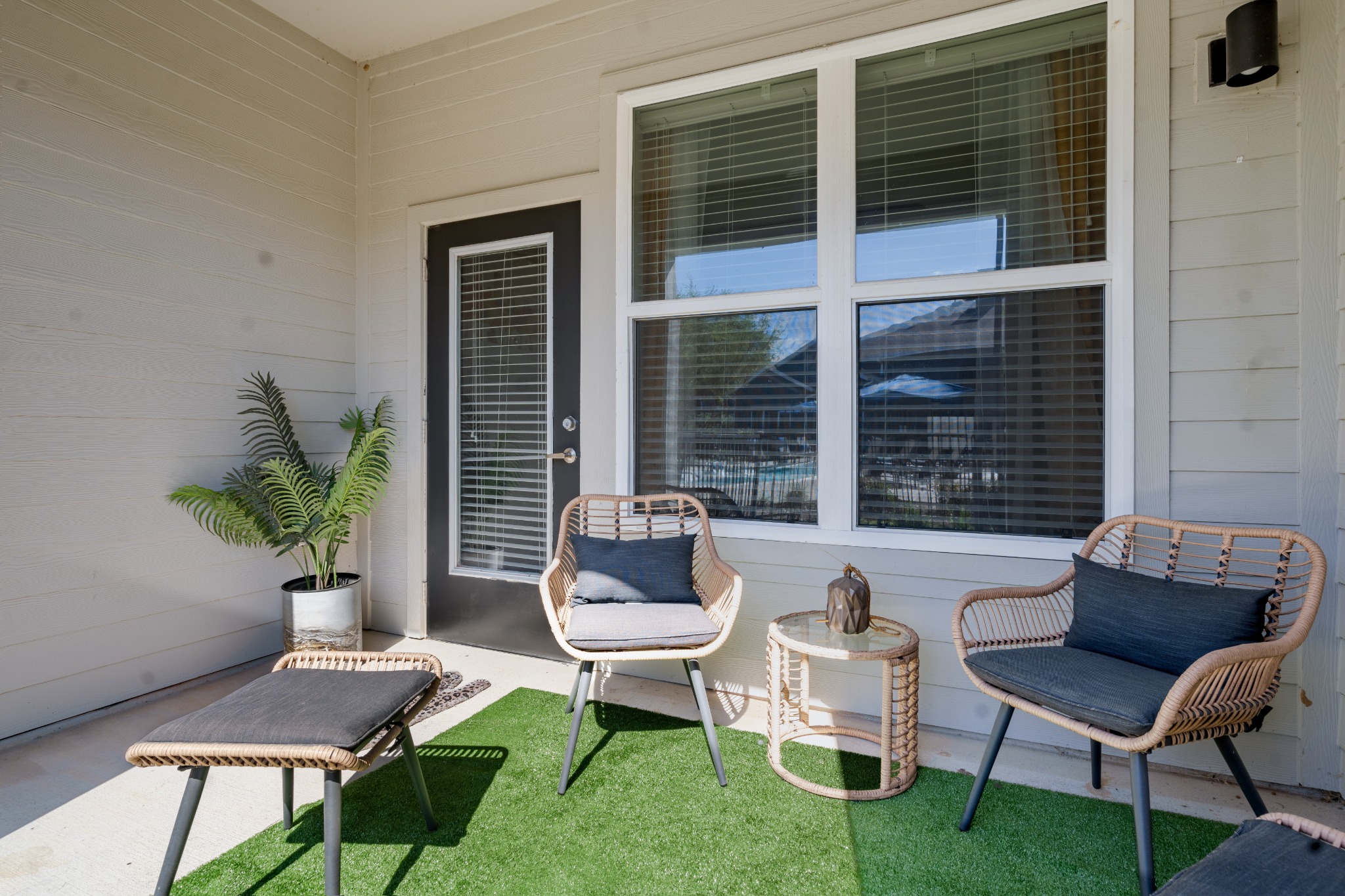 a patio with green grass and chairs at The Landmark at Crowley