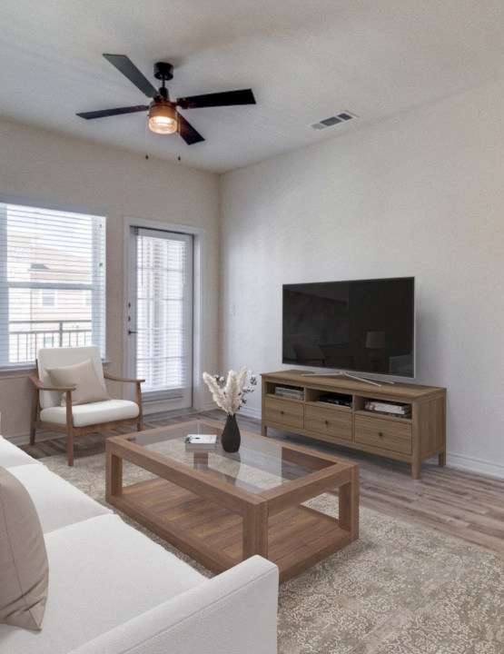 the living room of an apartment with a couch and a tv