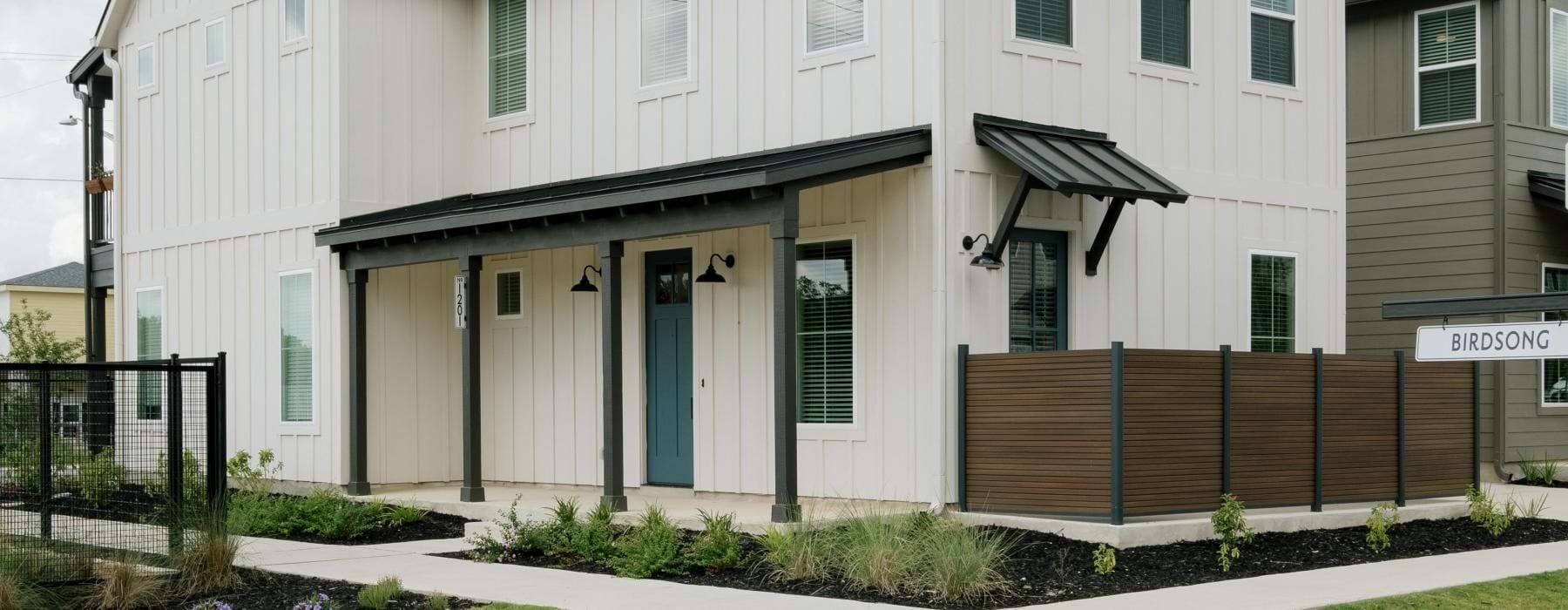 a building with a fence and a yard
