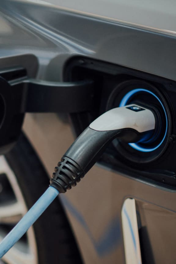 an electric car is being charged at a charging station