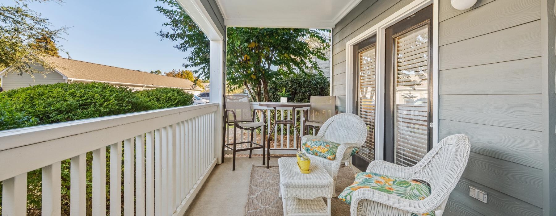 a patio with chairs and a table