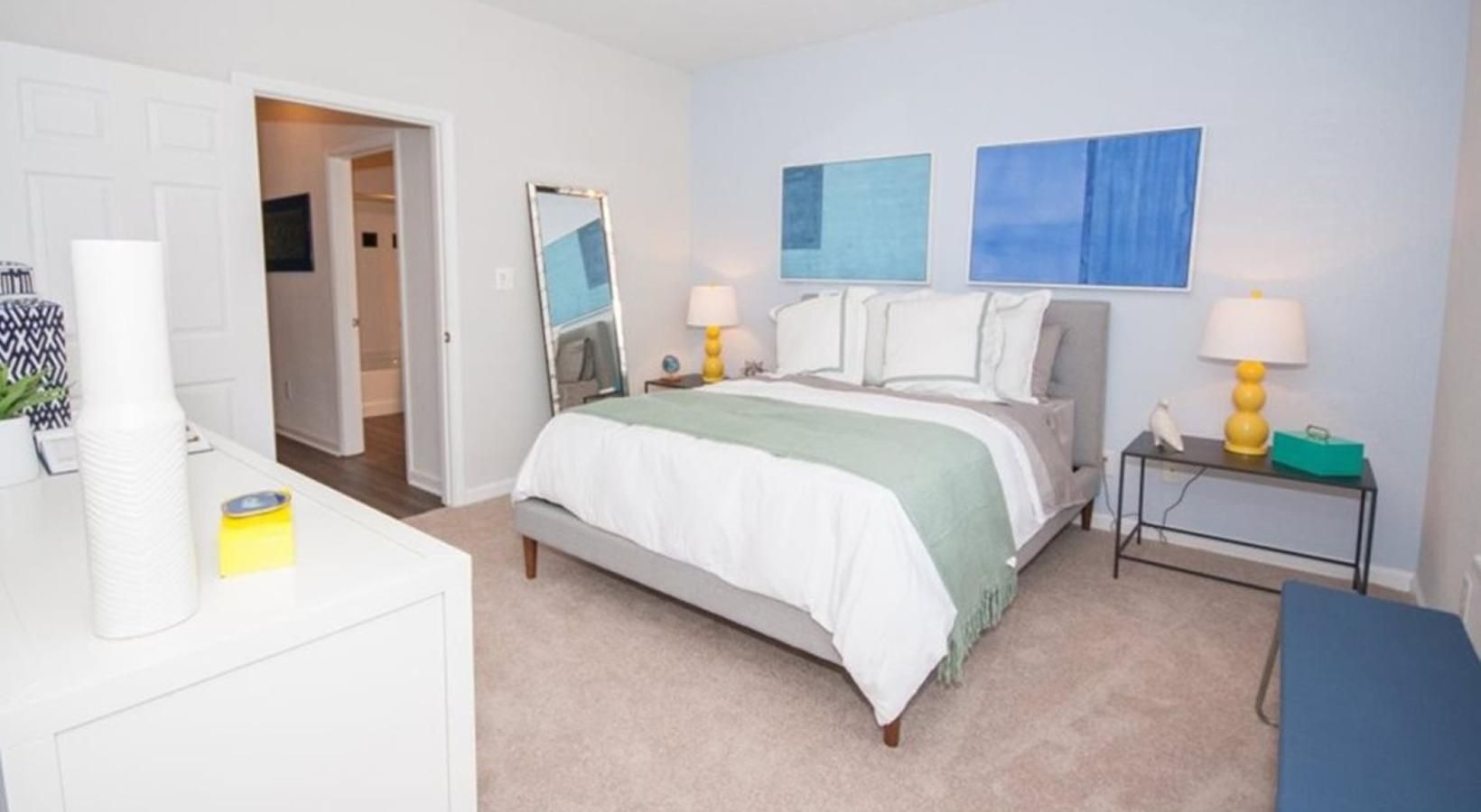 a bedroom with a bed and lamps