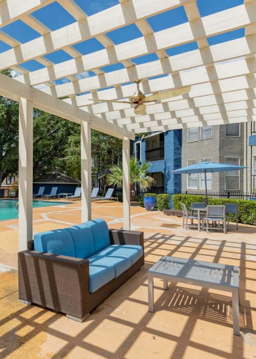 Covered seating by the pool at The Iris in San Antonio, Texas