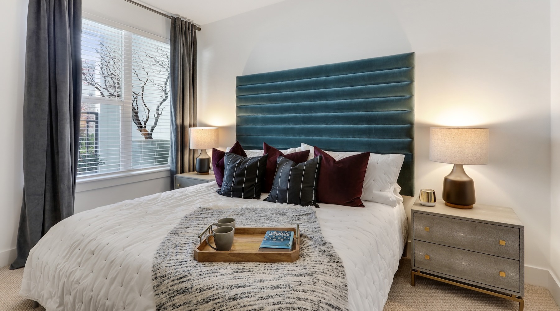 a bedroom with a bed and two nightstands