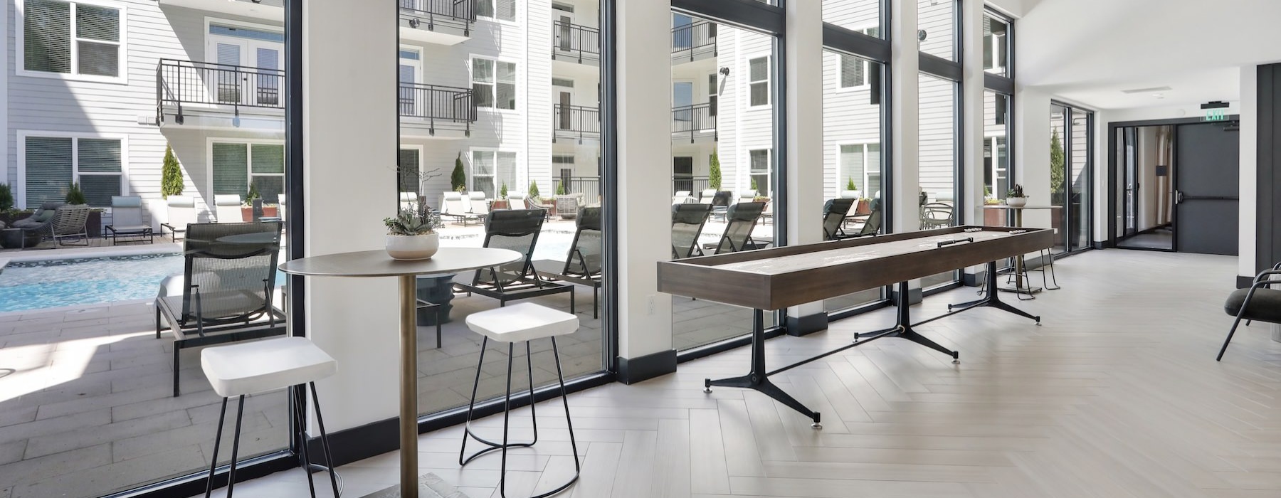 a clubroom with tables and chairs