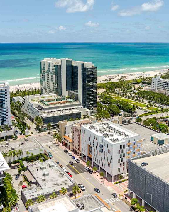 A cityscape with buildings and a beach in the background.