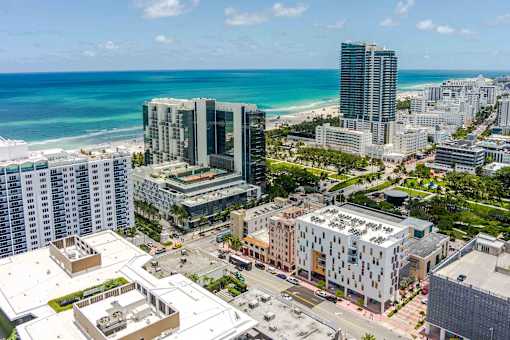 Cityscape view near The Anamar at Collins Park in Miami Beach, Florida, with buildings in the foreground and the beach in the background, highlighting the pet-friendly community's coastal location.