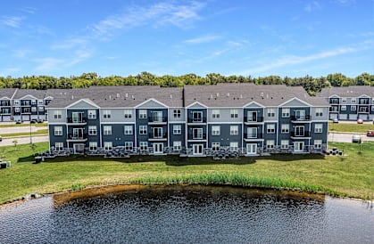 A large building with a pond in front of it.