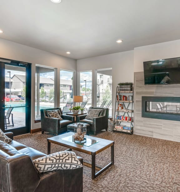 a living room with couches and chairs and a fireplace