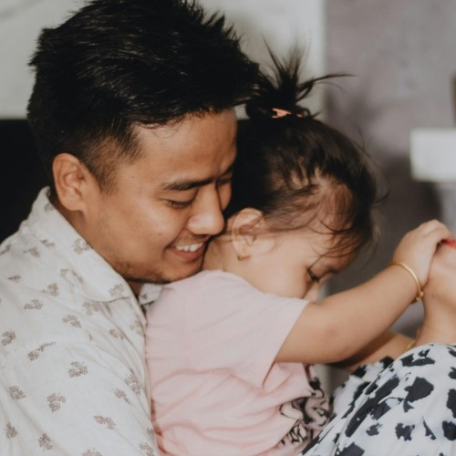 a family hugging and laughing