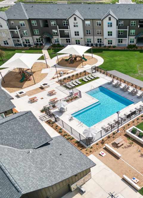 A Pool with Lounge Chairs at Anson Crossing Apartments, Maxwell, TX