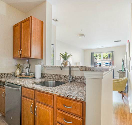 A kitchen with a sink and a refrigerator.