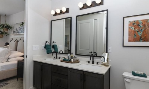 a bathroom with a sink and a bed