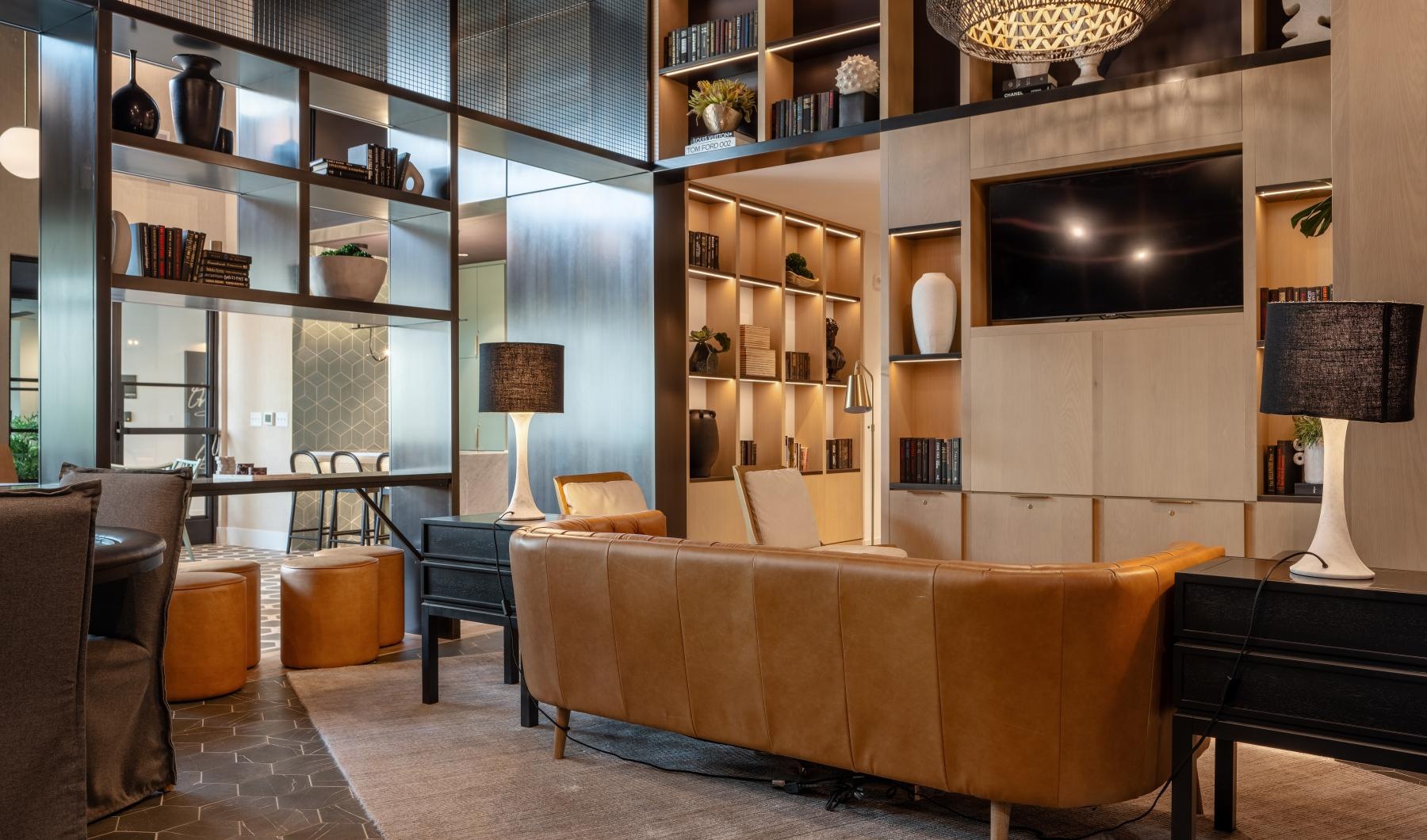 a clubroom with a tv, couch and lamps