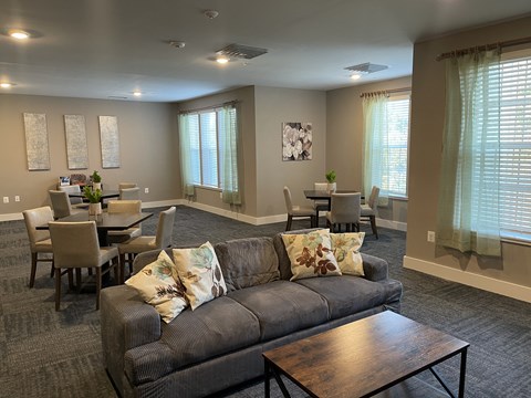 a living room with a couch and a table with chairs