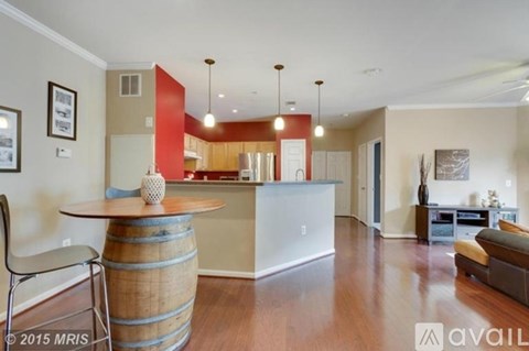 A living room with a barrel table and a couch.