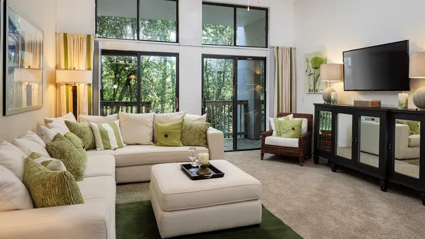 furnished living room with floor to ceiling windows
