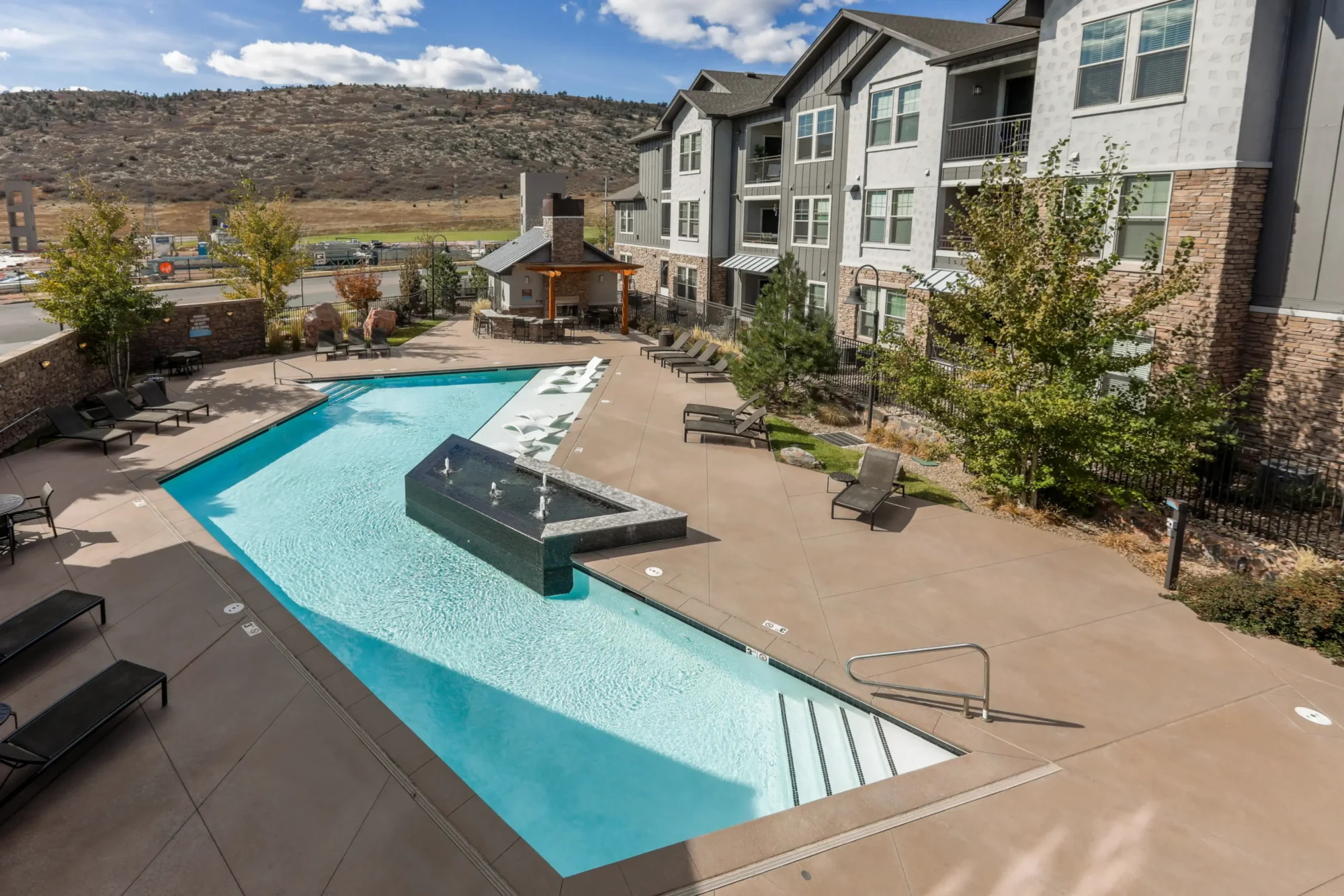 Pool with deck seating and outdoor fire place