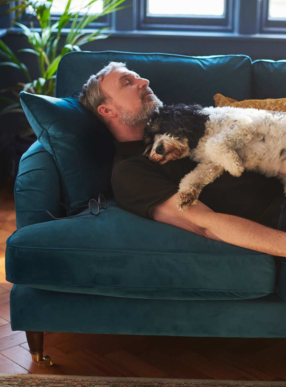 Person with dog on couch The Garnett in Brooklyn, New York