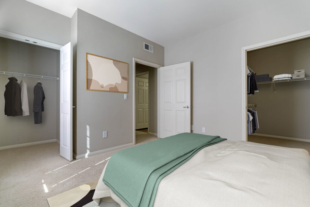 carpeted bedroom with two closets