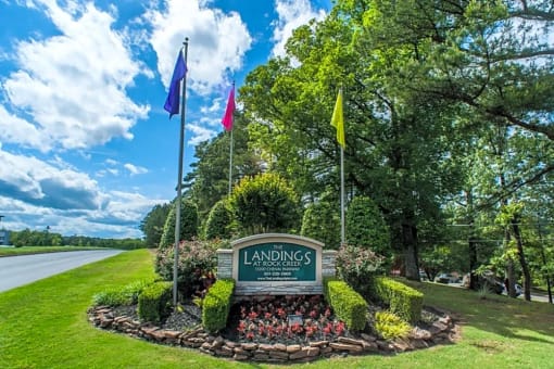 a view of a park with flags and a sign