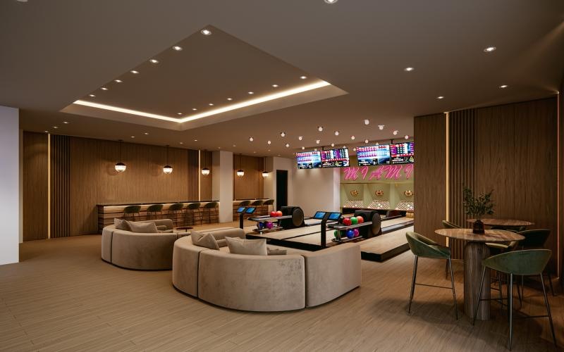 a room with couch and chairs and a bowling alley