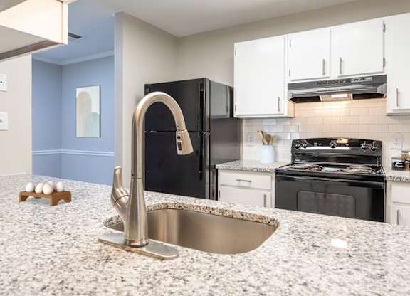 a kitchen with granite counter tops and black appliances at Henley, North Carolina, 28311