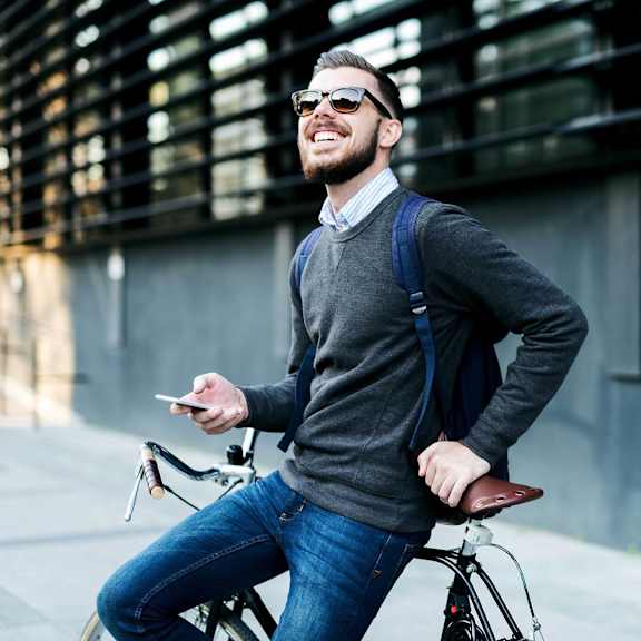 Two people riding bicycles in an urban setting.
