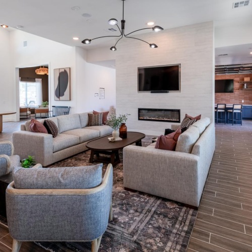 a living room with a large television and couches