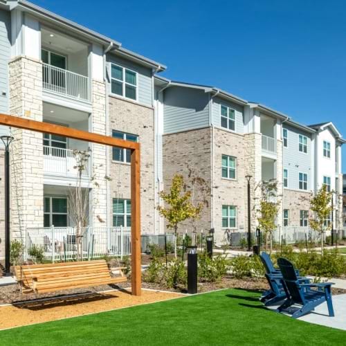 a building with a lawn and chairs