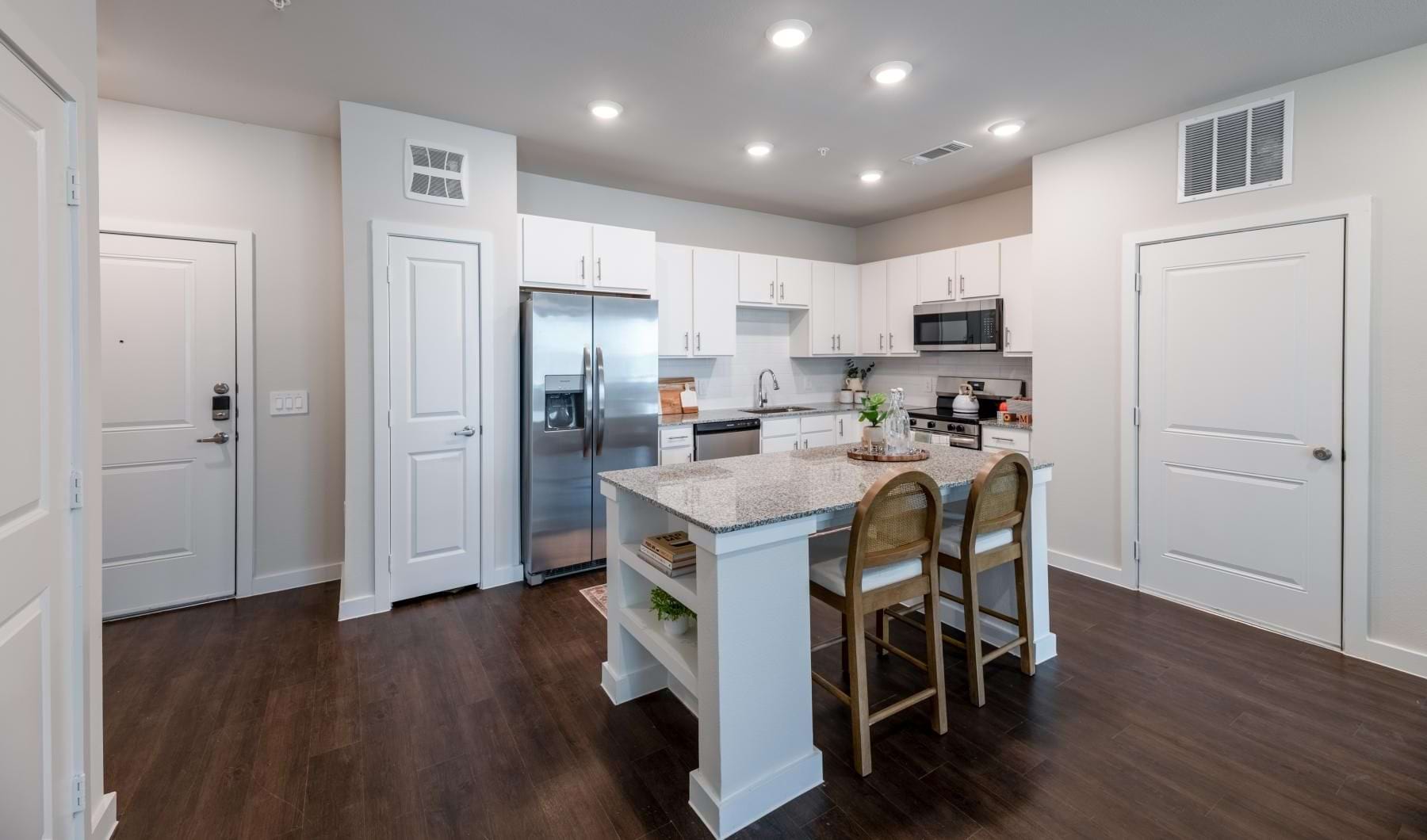 A kitchen with white cabinets at Ascend at 720 apartments in Cross Roads, TX.