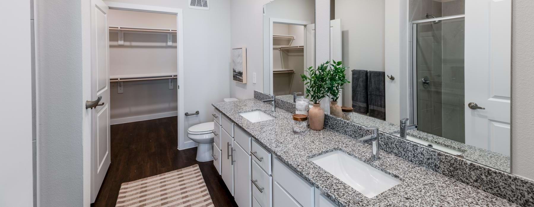 A bathroom with a marble countertop at Ascend at 720 Dallas Fort Worth apartments.