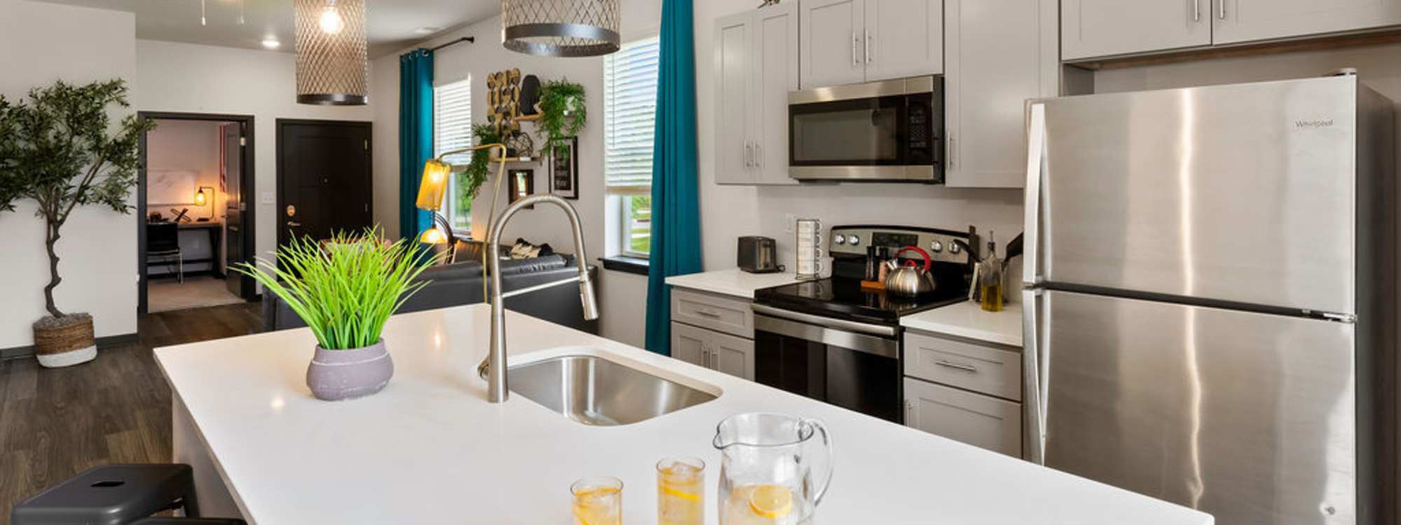 Kitchen with range and refrigerator at Atlas on 17th in Bloomington, Indiana