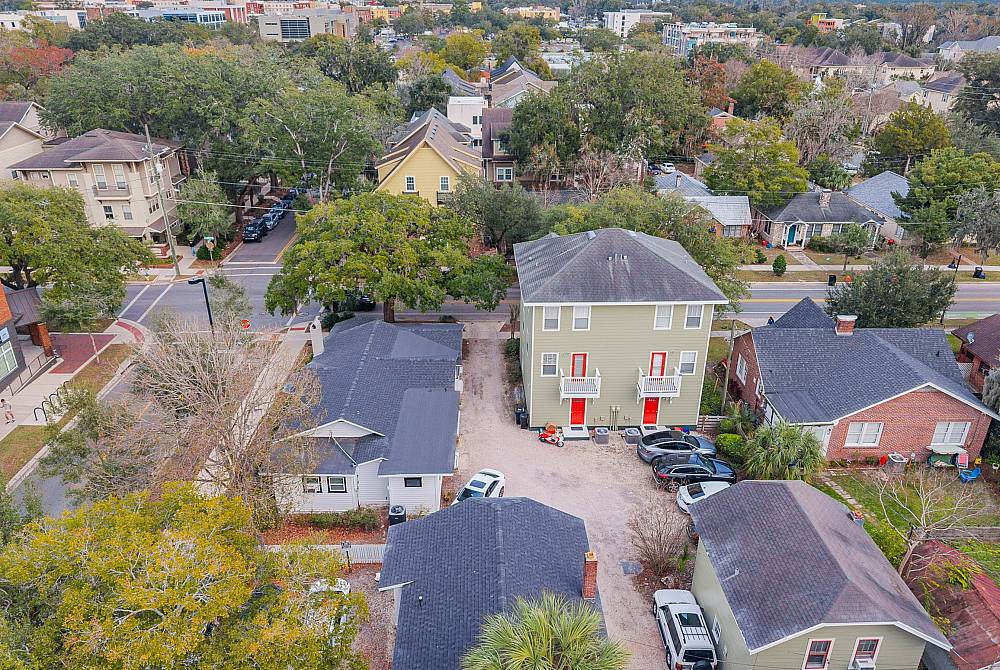 Charming aerial view of a quaint residential area showcasing cozy homes surrounded by lush greenery and vibrant community vibes.